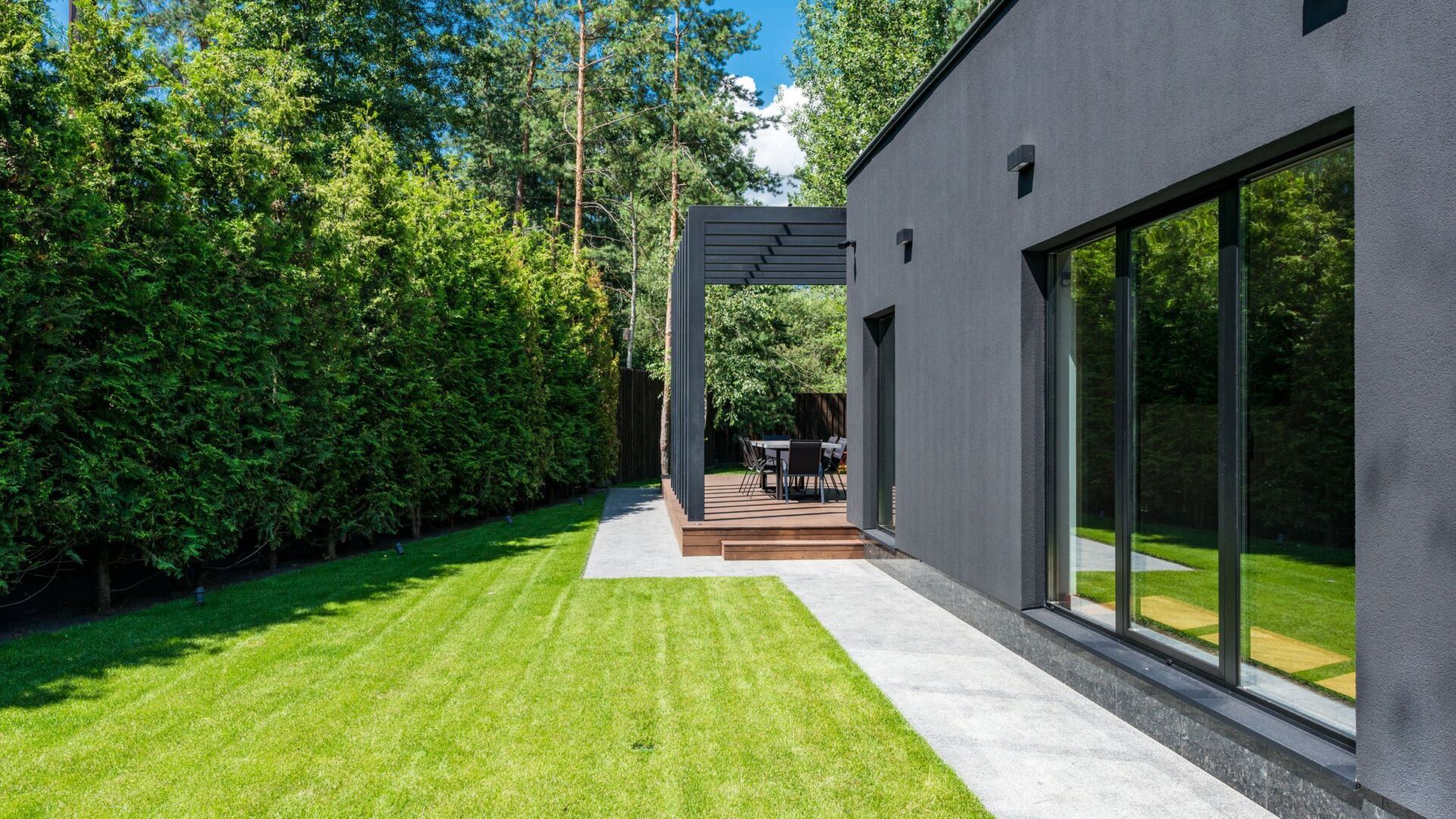 Modern home with a freshly cut lawn at dusk