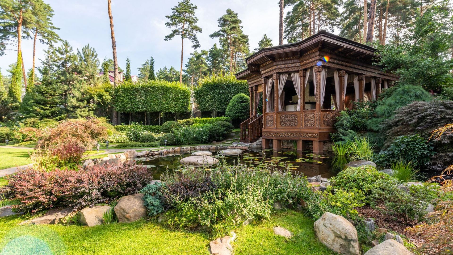 Layered planting beds around a garden pavilion