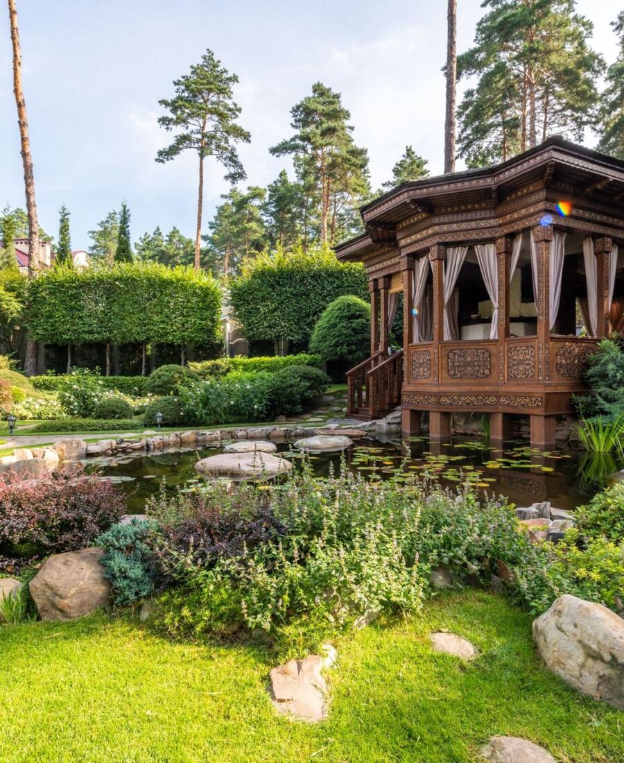 Layered planting beds around a garden pavilion